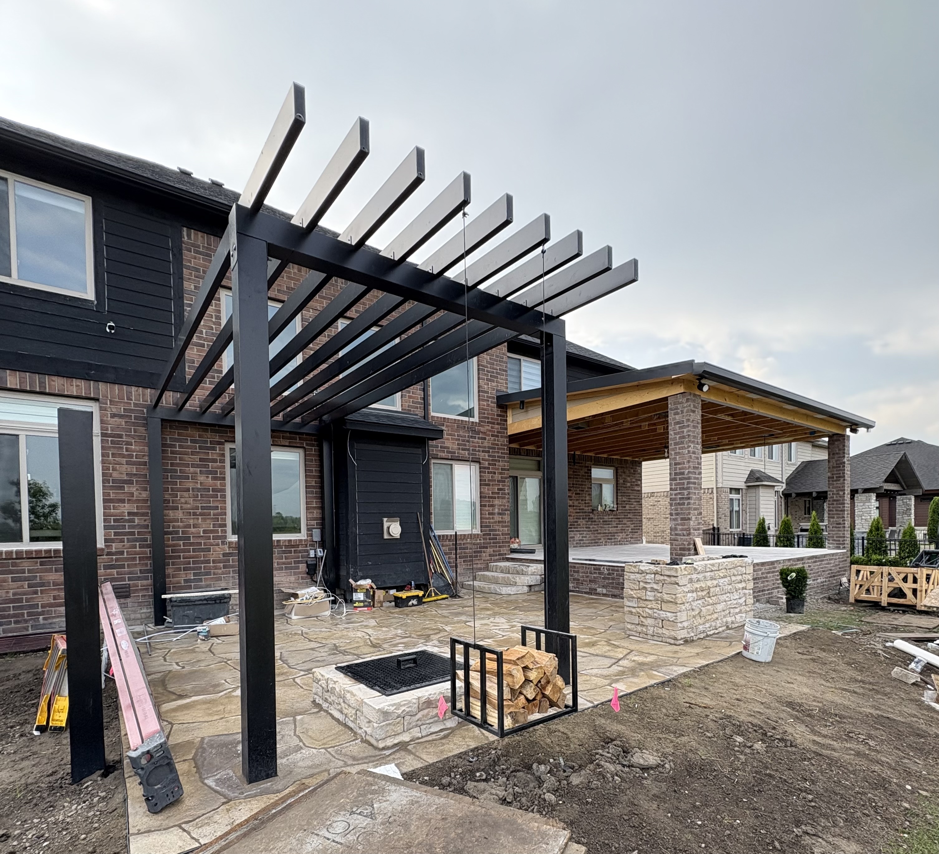 The wooden frame of a new deck being built onto the back of a house.